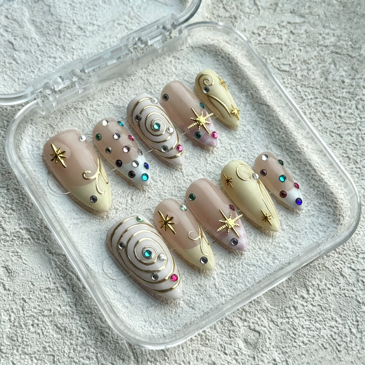 Celestial Magic almond press-on nails with 3D swirls, gold stars and rhinestones