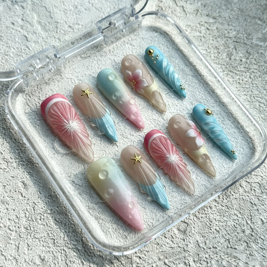 Dreamy Mirage long press-on nails with pastel watercolor, 3D swirls and gold stars