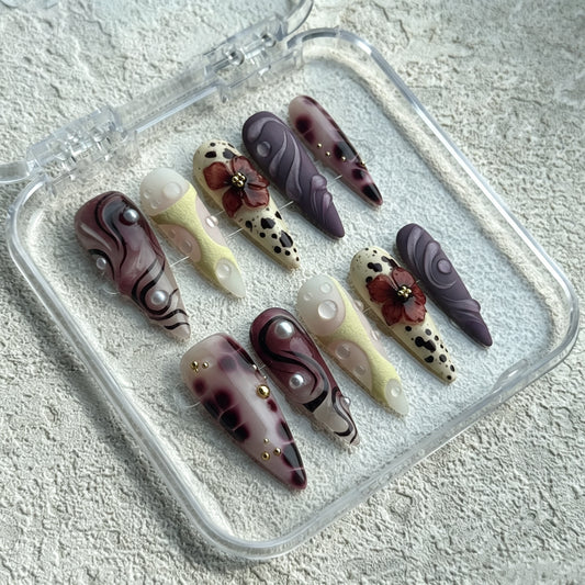 Amber Noir stiletto press-on nails with leopard print, burgundy roses and abstract lines