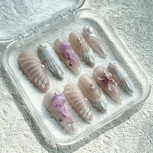 Siren's Shell almond press-on nails with lavender 3D shells, pearls and silver chrome